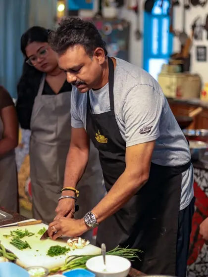 Our chef demonstrates the proper knife skills for preparing vegetables, a crucial part of our hands-on teaching philosophy.