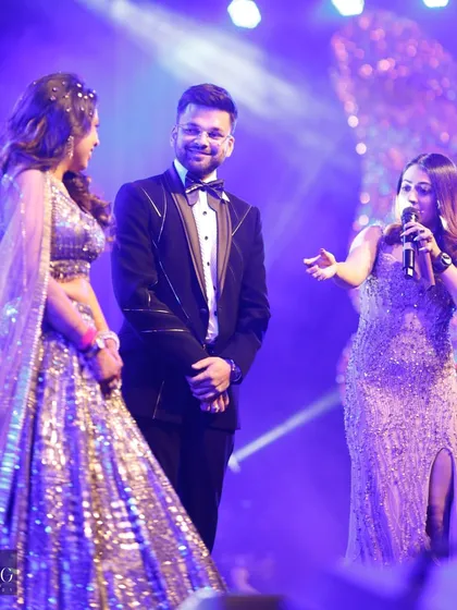 Guiding the couple through their Sangeet night formalities. Against a glittering backdrop, I ensure every part of the program flows smoothly while keeping the mood light and celebratory.