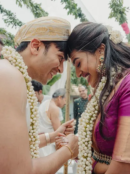 A close-up of a couple during a wedding ritual, their faces close together, capturing the intimacy and tradition of the moment.
