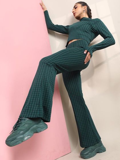 A sporty-chic look featuring a matching jacquard knit set. I paired the flared pants and crop top with chunky monochrome sneakers for a comfortable yet stylish outfit.