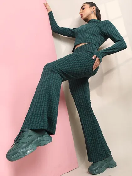 A sporty-chic look featuring a matching jacquard knit set. I paired the flared pants and crop top with chunky monochrome sneakers for a comfortable yet stylish outfit.