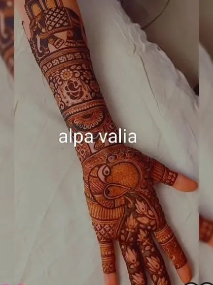 The full hand view of the royal design, showing the elephant and Ganpati motifs on the arm and a peacock on the palm.