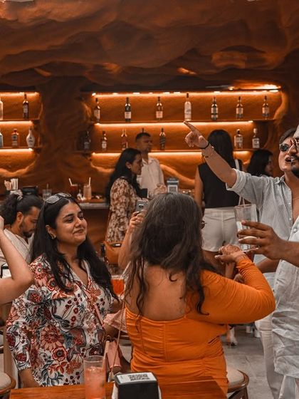 Guests enjoying a Sunday brunch, with some dancing and others relaxing. The music is curated to fit this multi-faceted social environment.