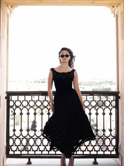 A full-length view of Alia Bhatt's timeless look. The soft waves and healthy shine of her hair add a touch of glamour that completes the entire ensemble.