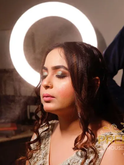 A behind-the-scenes moment. Here I am, setting the makeup with a fine mist to lock everything in place, with the ring light creating a beautiful halo effect.