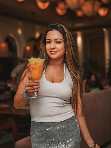 A guest raises her glass, enjoying a magical night at my place, where every event is more than a gathering, it's an experience.