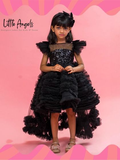 The "Spicy Black" dress features a high low hem with layers of structured ruffles and a sequined bodice.