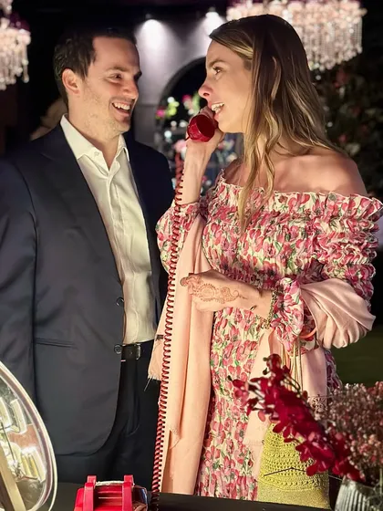 A quiet moment shared between a couple at their own celebration. The audio guestbook offers a chance for everyone, including the hosts, to capture a personal, heartfelt message amidst the whirlwind of the party.