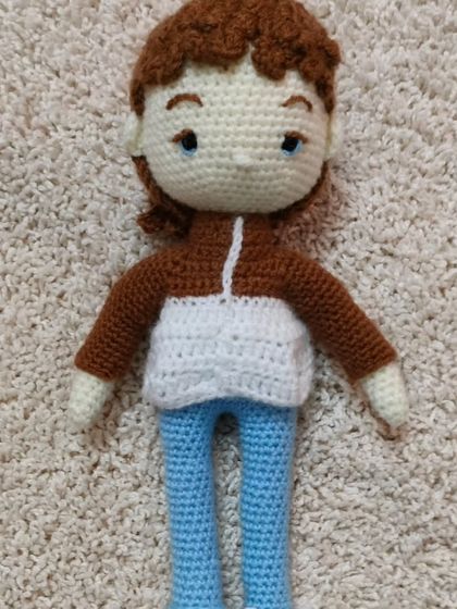 A handsome male doll with brown hair and a stylish jacket. All my dolls are made with soft, high quality yarn.