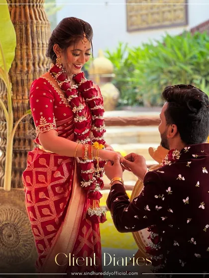 A beautiful proposal moment, with the bride-to-be looking stunning in our red Banarasi Bandhani saree.