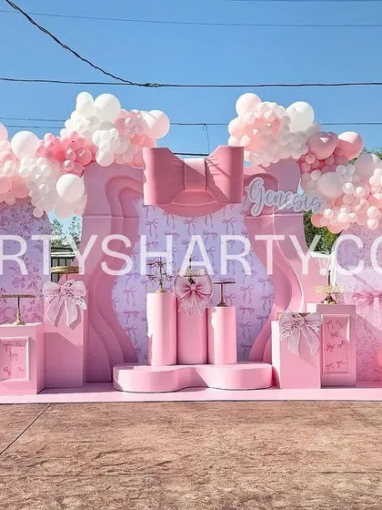 Our services extend to beautiful outdoor celebrations, perfect for birthdays or baby showers. This elegant all-pink setup features a modern, sculpted backdrop and organic balloon arches, creating a chic and sophisticated look.