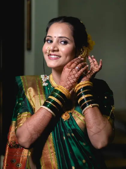Soft glam meets timeless tradition. This bride's look for her wedding day features a subtle smokey eye, a natural lip color, and a radiant base that enhances her beautiful smile.