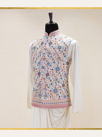 A mannequin displays a white Jawahar jacket with exquisite, multi-colored floral embroidery over a draped kurta. The ethereal beauty of this subtle color palette is ideal for summer functions.