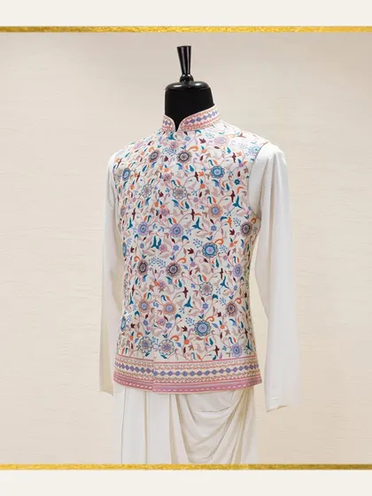 A mannequin displays a white Jawahar jacket with exquisite, multi-colored floral embroidery over a draped kurta. The ethereal beauty of this subtle color palette is ideal for summer functions.