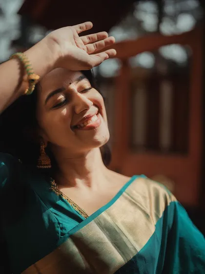 Mirnalini basking in the sunlight. The warm light highlights her glowing skin and happy expression, creating a stunning, sun-kissed portrait.
