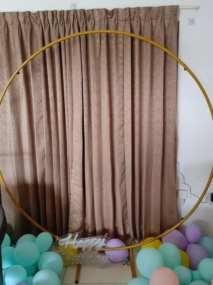 A bare gold-colored metal ring stand, ready to be decorated for any occasion.