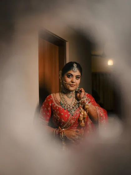 A creative portrait of a bride seen through a circular frame, adding an artistic touch and drawing focus to her beautiful expression.