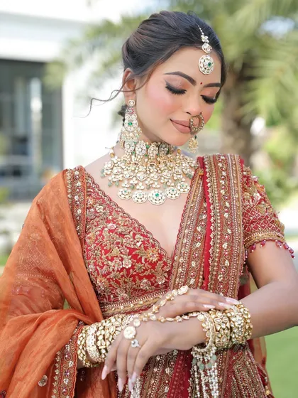 A close-up on the bridal look, focusing on the stunning jewelry and the detailed embroidery of the blouse. Every element comes together to create a look of pure royalty.