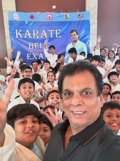 Waving to the camera with my students. Conducting belt exams personally allows me to assess the progress of our young karatekas.