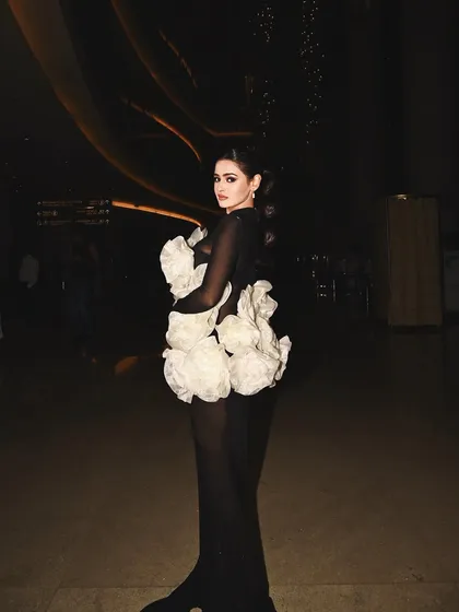 A full-length view of the dramatic floral gown, where my hair and makeup work to balance the volume of the dress and create a cohesive, high-fashion statement.
