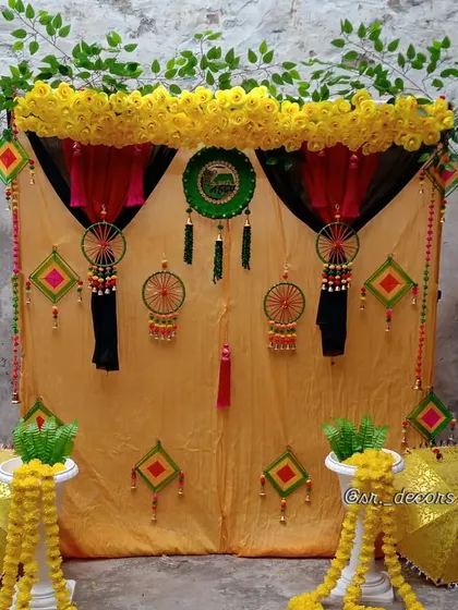 I create authentic and traditional Haldi setups right at your home. This decor uses a classic yellow marigold theme with gota patti hangings and decorative umbrellas for a truly desi function.