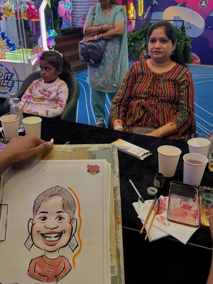 My art station set up at a party, showing the watercolors and pens I use to create my live drawings.