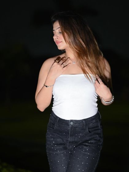 A soft and gentle pose that contrasts with the edgy night-time environment.