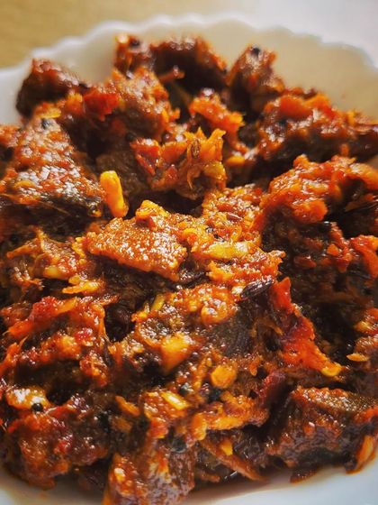 A close-up of the texture of my buff chunks pickle. Each piece is coated in a thick, spicy masala that I prepare myself.