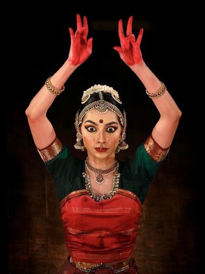 A powerful moment from a performance, portraying the fierce energy of the goddess Kali. This is 'Raudra' rasa, the emotion of anger and fury.