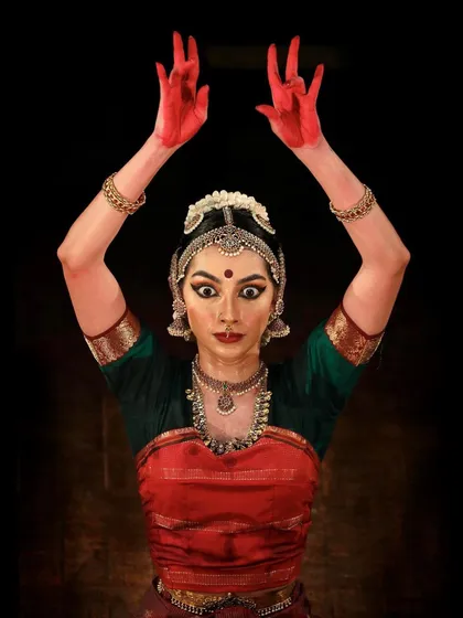 A powerful moment from a performance, portraying the fierce energy of the goddess Kali. This is 'Raudra' rasa, the emotion of anger and fury.