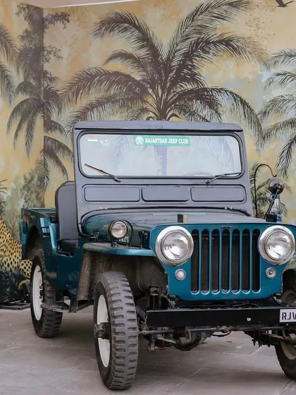 A vintage jeep parked in front of a safari-themed wallpaper created the perfect photo opportunity for guests, adding an element of adventure and fun to the event.
