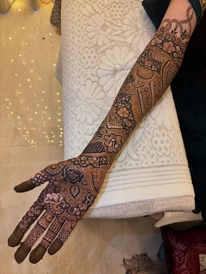 The full arm view, where you can see the 'R' initial clearly visible amongst the dense patterns. It's like a beautiful secret hidden in the art.