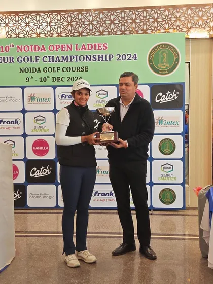 Shrestha Shukla receives her trophy after her victory in the Open Category at the 10th Noida Open Ladies Amateurs, a commendable performance.