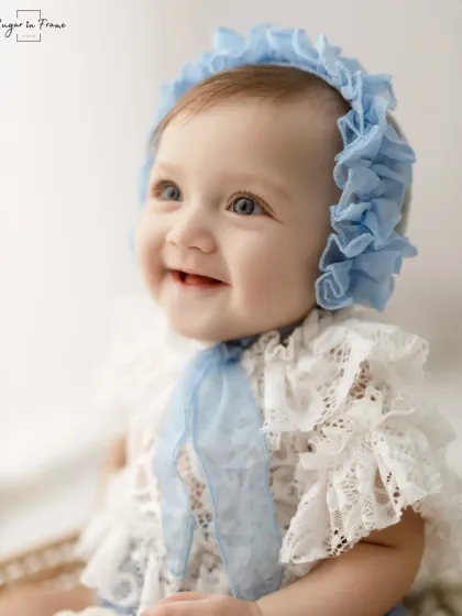 Another beautiful close-up, this time capturing a sweet, gentle smile that shows off her first two teeth.