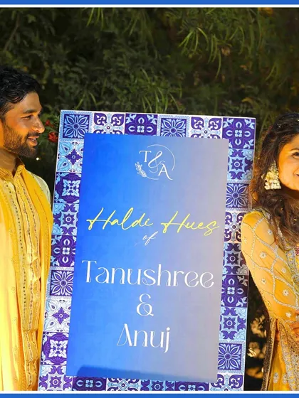 The official welcome sign for the "Haldi Hues of Tanushree & Anuj," featuring the blue pottery design.