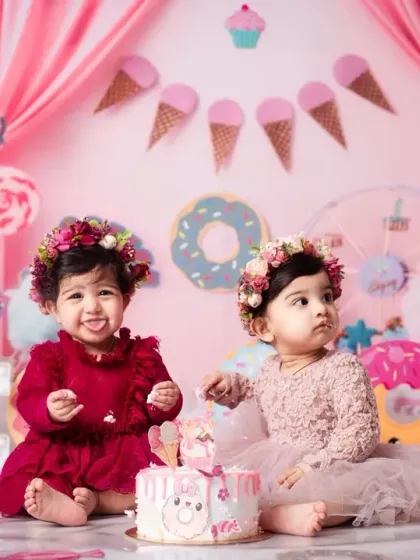 We go all out for first birthdays! This sweet duo is celebrating in our custom 'Candy Land' theme, one of the many imaginative worlds we can create for your child's special day.