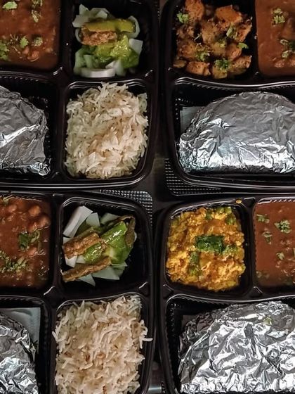 A variety of our affordable lunch thalis, priced at just 130 rupees. You can see options like chole, paneer bhurji, and aloo gobhi.