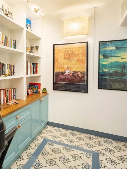 Another angle of the study room from image 31, highlighting the custom bookshelves and movie poster art.