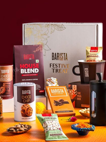 A festive Barista gift hamper, showcasing a coffee mug, beans, cookies, and nuts for a complete coffee lover's package.