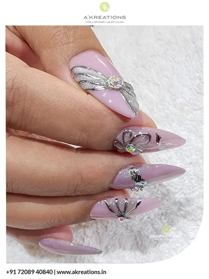 This side view highlights the profile of the stiletto nails and the raised 3D bow and floral designs, showing the intricate sculpting work involved.