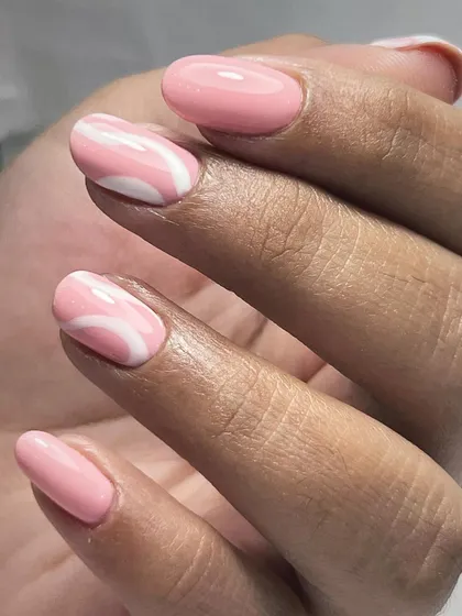 A simple yet beautiful Russian manicure with abstract swirl art. The soft pink base is accented with clean white lines for a modern and minimalist design.