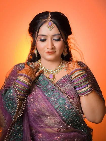 A ring ceremony portrait with a warm, orange-gradient background, giving the image a soft and celebratory glow.