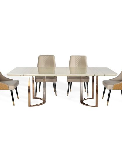 This complete dining set includes a marble top table with a rose gold PVD base and four matching chairs. The chairs feature a dual-texture design with smooth suede seats and quilted leatherette backs.