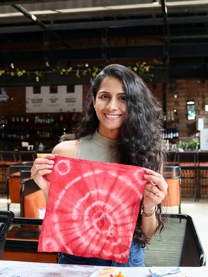 Another happy creator showing off her beautiful spiral tie-dye napkin. It's so rewarding to see people connect with this craft and leave with something they made themselves.