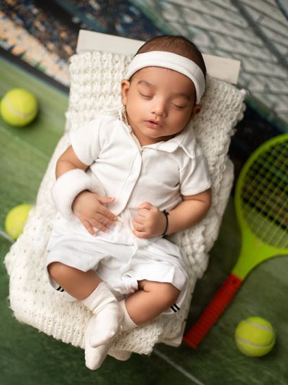 Game, set, match. For the sports-loving family, a tennis-themed newborn shoot is a fun way to celebrate your passion with your newest team member.
