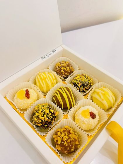 A clean, elegant shot of my assorted truffle box in a simple white gift box. These handcrafted chocolates are a perfect and luxurious gift for Raksha Bandhan.