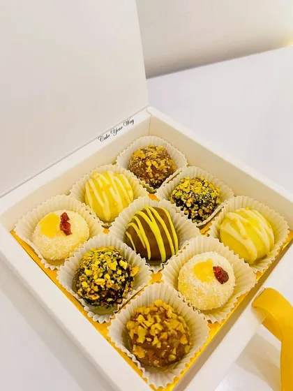 A clean, elegant shot of my assorted truffle box in a simple white gift box. These handcrafted chocolates are a perfect and luxurious gift for Raksha Bandhan.