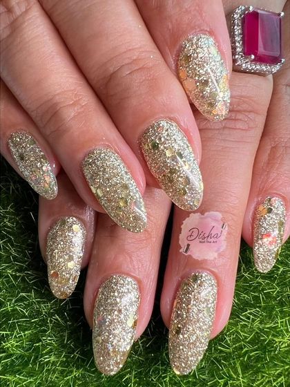 A full set of glamorous gold glitter nails, perfect for any party or celebration.