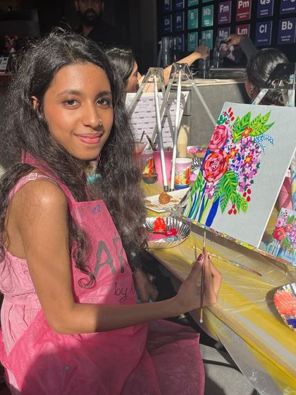 A participant at a floral workshop, deeply engrossed in her painting. The process is as enjoyable as the final result.