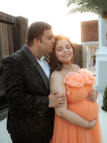 An intimate moment captured during a golden-hour maternity shoot. The expecting mother glows in our orange 'Isabella' gown, which is made of comfortable, stretchable lycra.